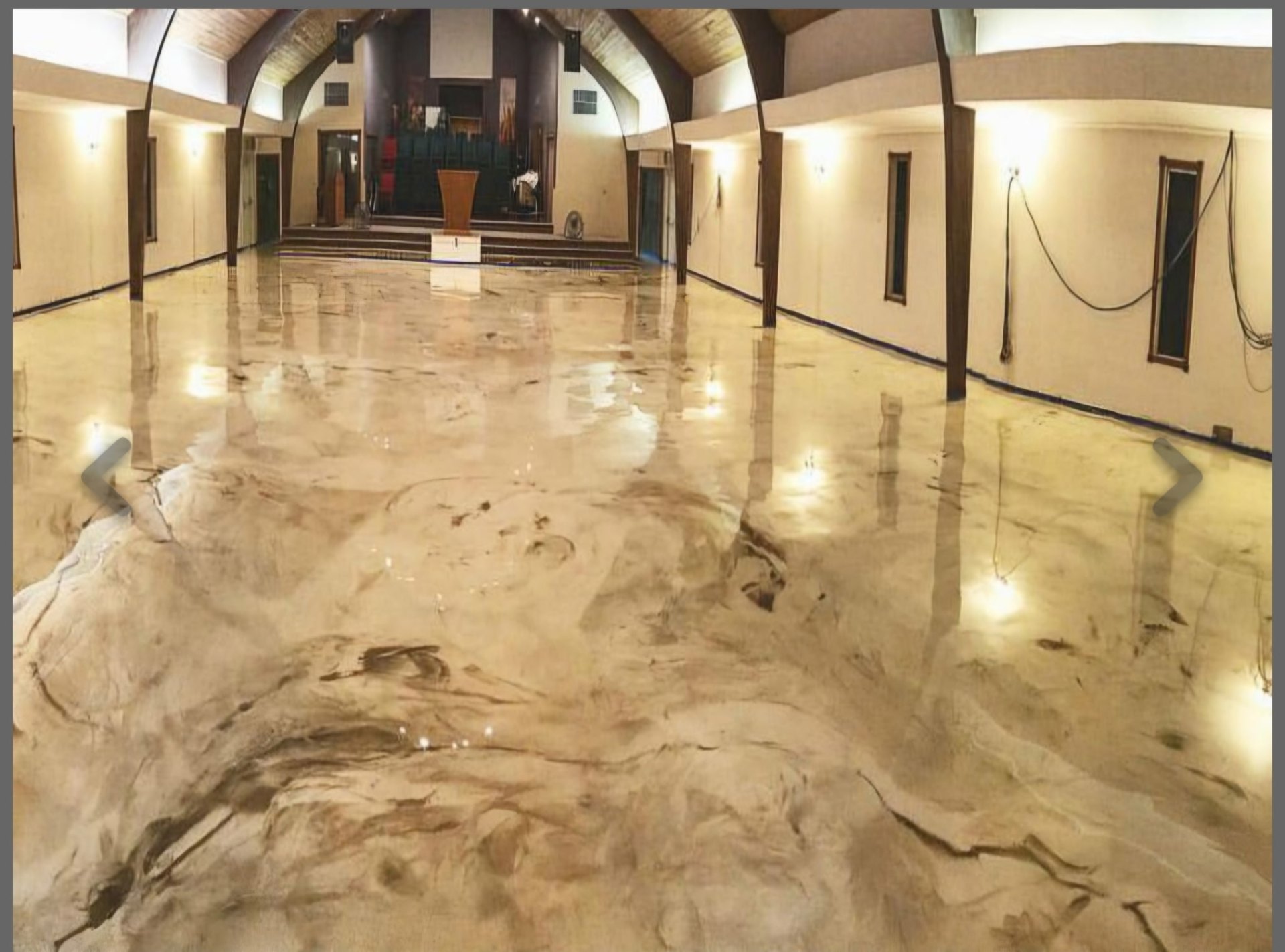 Large-format metallic epoxy floor in a commercial hall